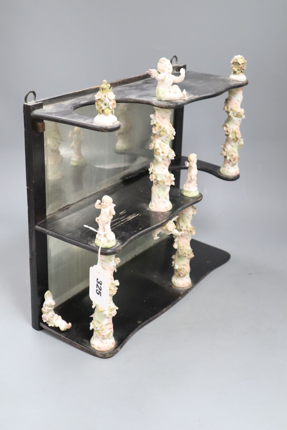 A decorative ceramic and wooden and mirrored wall shelf, height 35cm width 35cm